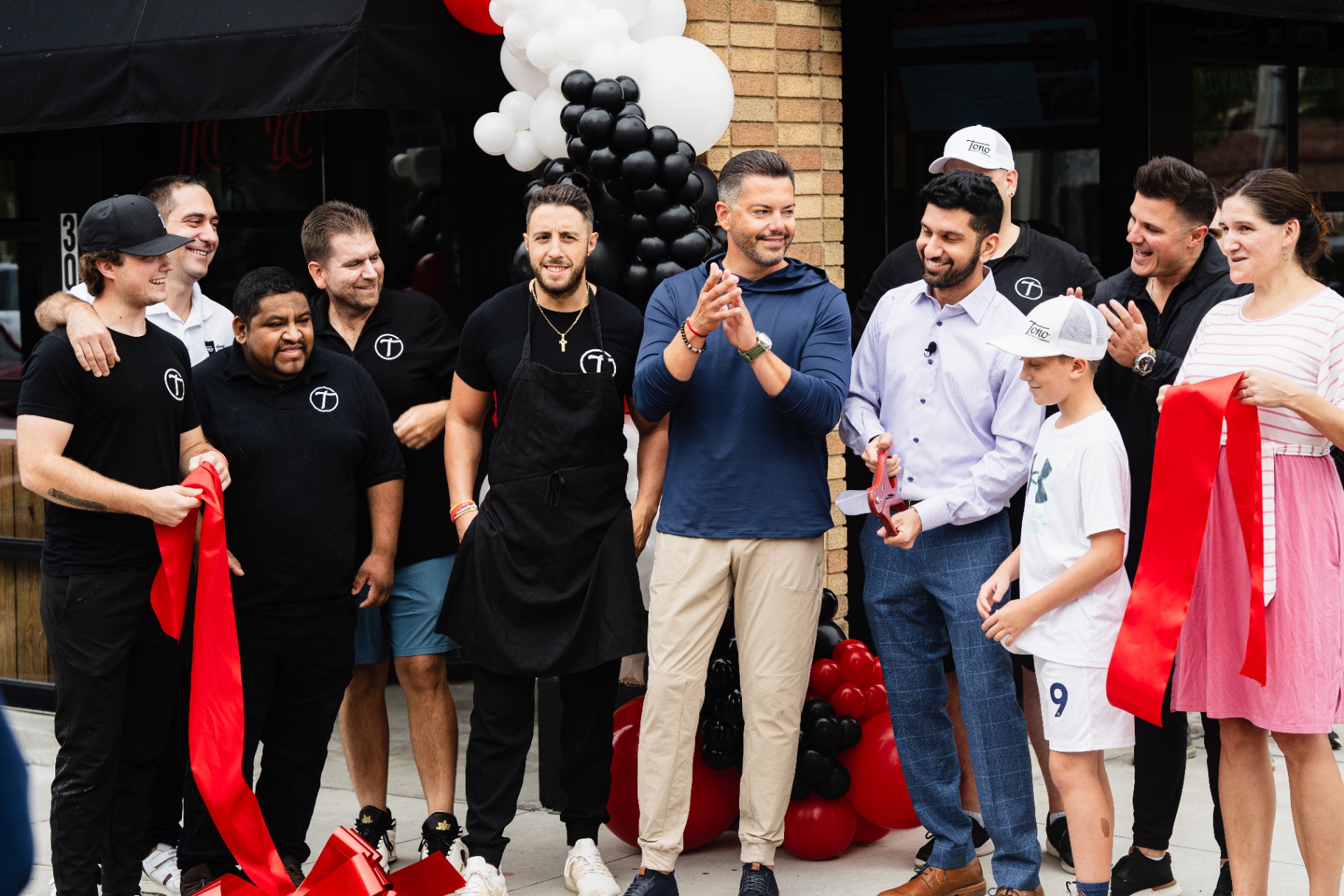 Tono grand opening ribbon cutting with team