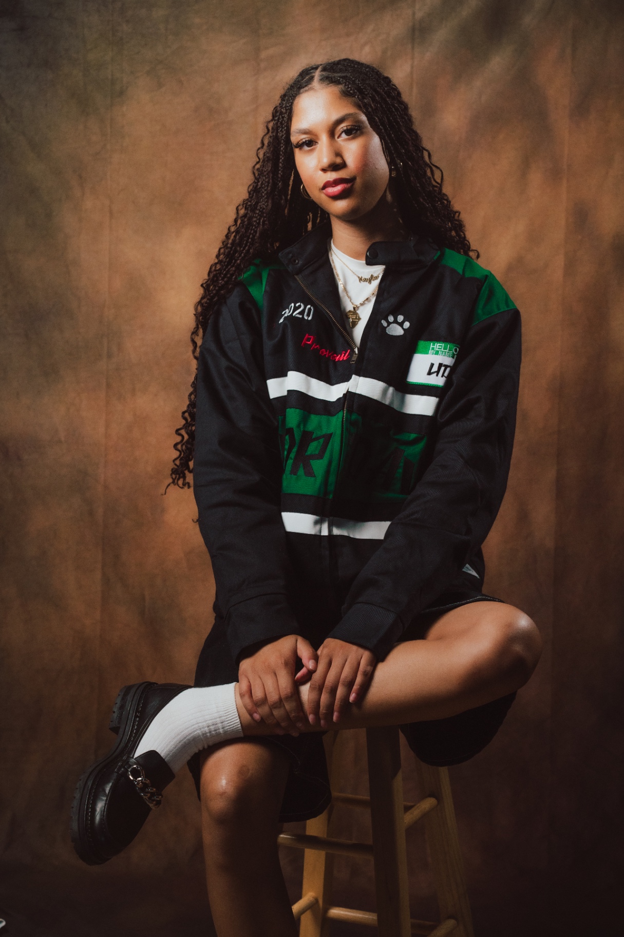 Undrdawg seated portrait in varsity jacket