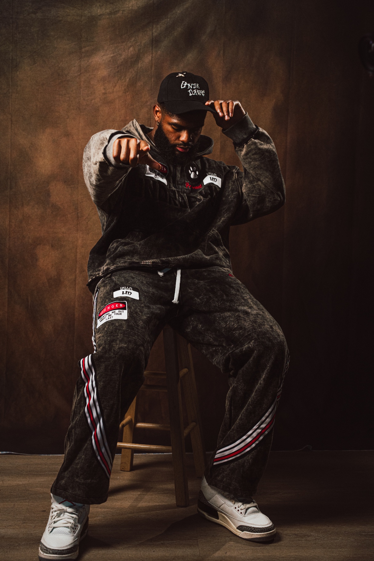 Undrdawg studio portrait seated on stool