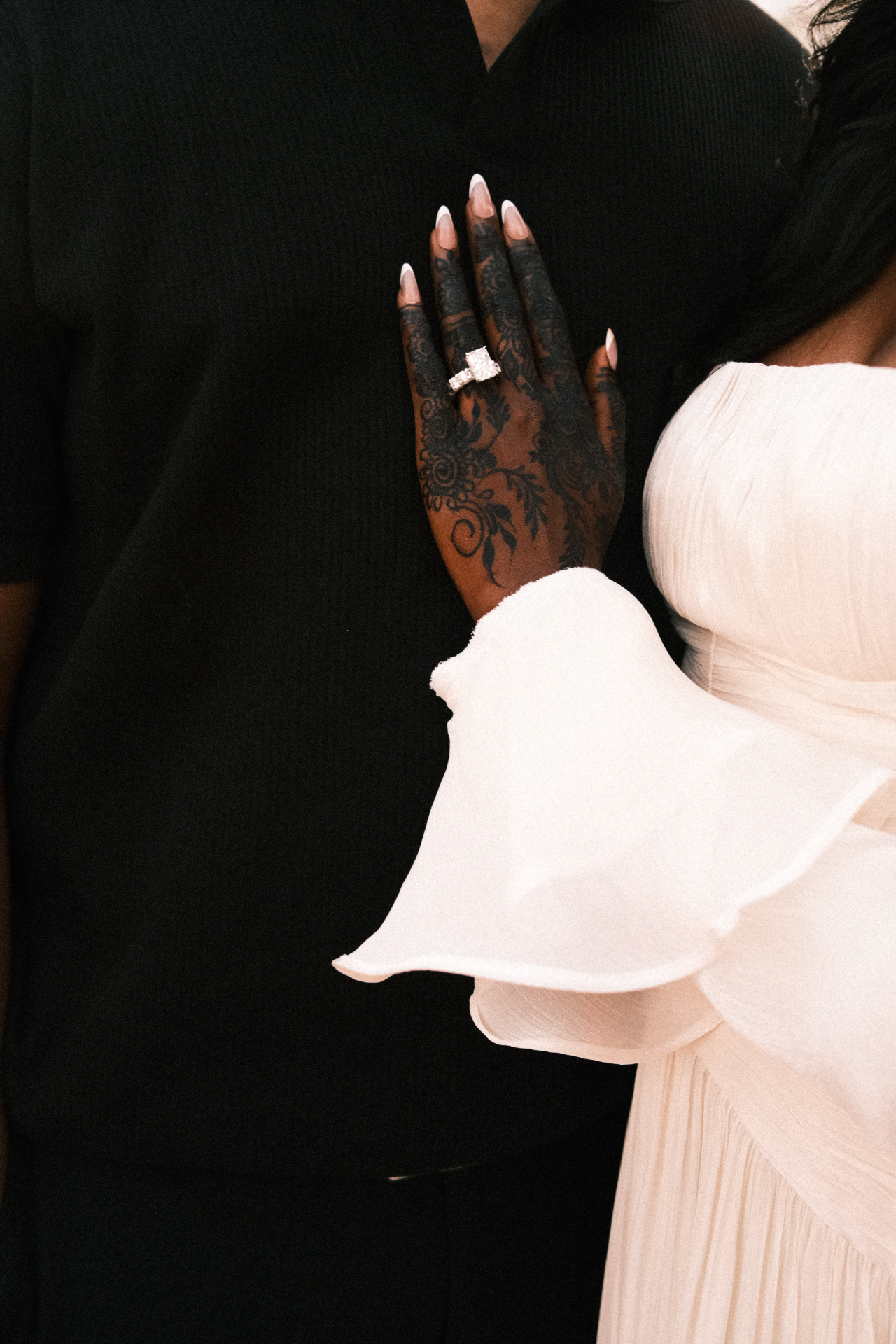 Henna hand on his chest — ring detail
