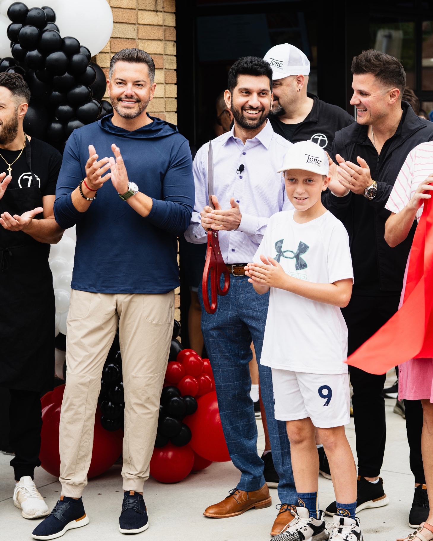 Tono owners applauding at ribbon cutting